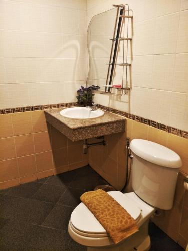 a bathroom with a toilet and a sink at Blue House Sukhothai in Sukhothai