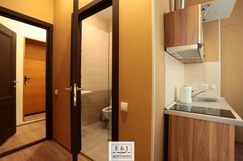 a bathroom with a sink and a door at Apartment E&J in Krasnoyarsk