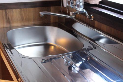 a stainless steel sink in a kitchen at Nangoku Lodge Booya in Onna