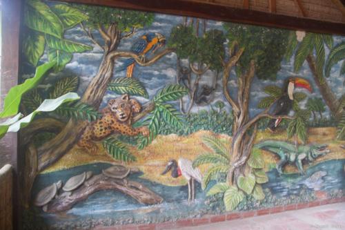 a mural of a jungle with a cheetah and birds at Hotel Ambaibo in Rurrenabaque