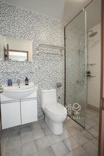 a bathroom with a toilet and a sink and a shower at Fa Dai Homestay in Magong