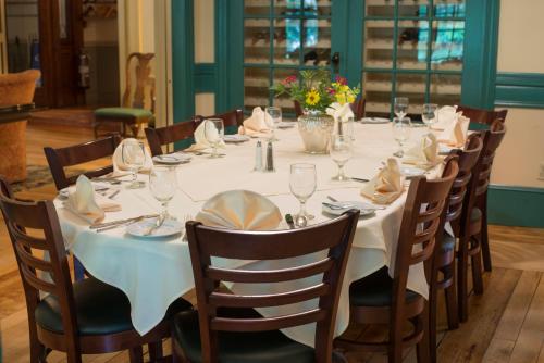 a long table with a white table cloth and chairs at The Norwich Inn in Norwich