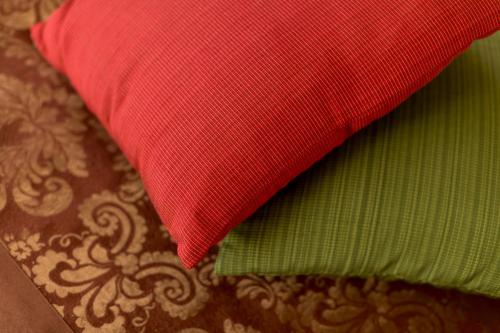 a red pillow sitting on top of a table at Eco Tree Hotel Sheung Wan in Hong Kong