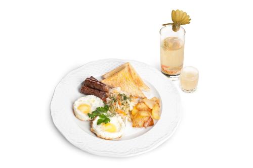 a plate of breakfast food with eggs sausage and toast at Boutique Hotel Traditional in Astana