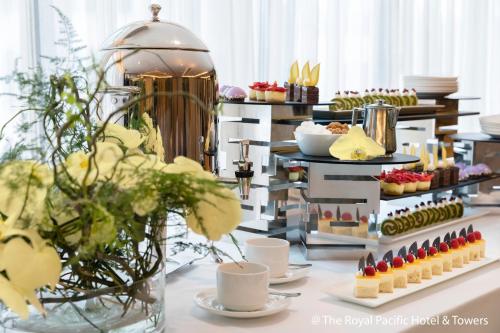 a buffet line with desserts and pastries on a table at The Royal Pacific Hotel & Towers in Hong Kong