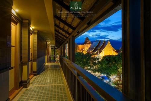 a balcony with a view of a city at night at Chala Number6 in Chiang Mai