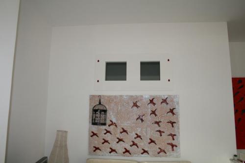 a wall with a birdcage and a bird cage at B&B Mini Hotel Incity-close train station and port- in Salerno