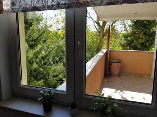 a window with a view of a balcony with plants at Apartment 40 in Zagreb