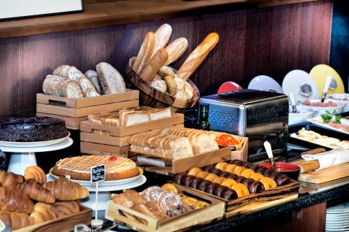 a display of different types of bread and pastries at Best Western Plus Hotel Alfa Aeropuerto in Barcelona