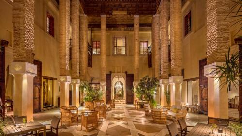 a large room with tables and chairs in a building at Karawan Riad in Fès