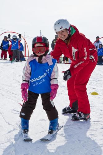 a woman and a child on skis in the snow at Haus Rudigier by Châtel Reizen in Sankt Gallenkirch
