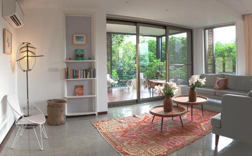 a living room with a couch and a table at Bungalow 99 in New Delhi