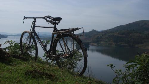 a bike parked on a hill next to a lake at Amasiko Homestay Lake Bunyonyi in Kabale