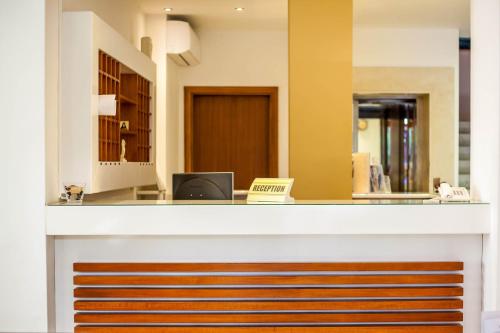 an office with a reception desk with a laptop at Filmar Hotel, Ixia, Rhodes in Ixia