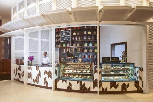 a bakery with a man standing behind a display at Amari Johor Bahru in Johor Bahru