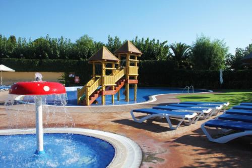 a water park with a slide and a playground at Camping Joan Bungalow Park in Cambrils