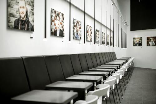 a row of benches in a room with pictures at Wakeup Copenhagen - Borgergade in Copenhagen