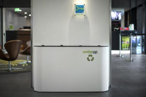a white refrigerator with a sign on top of it at Wakeup Copenhagen - Borgergade in Copenhagen