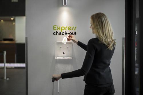a woman is standing in front of a refrigerator at Wakeup Copenhagen - Borgergade in Copenhagen