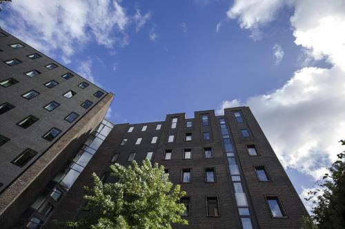 two tall buildings with the sky in the background at Wakeup Copenhagen - Borgergade in Copenhagen