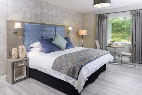 a bedroom with a large bed with a blue headboard at Sea View Apartment in Kenmare