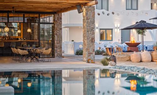 a villa with a swimming pool and a house at Portes Suites & Villas Mykonos in Mýkonos City