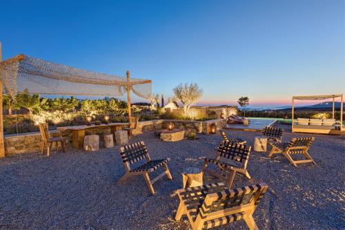 a group of wooden benches sitting in a park at Portes Suites & Villas Mykonos in Mýkonos City