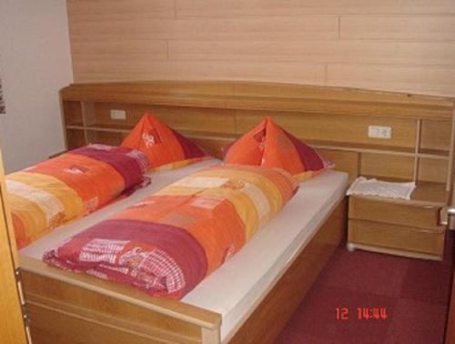 a bed with two pillows on it in a room at Haus Salzgeber Angelika in Schruns-Tschagguns