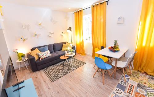 a living room with a couch and a table at Parliament & River View Apartments in Bucharest