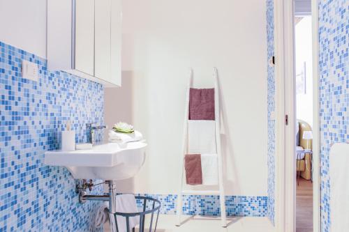 a bathroom with a sink and blue tiles at Centrale Mazzoni 15 in Venice