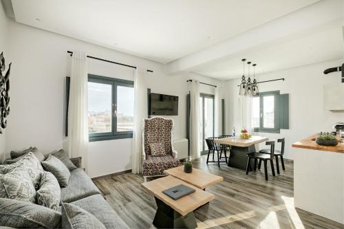 a living room with a couch and a table at Portes Suites & Villas Mykonos in Mýkonos City