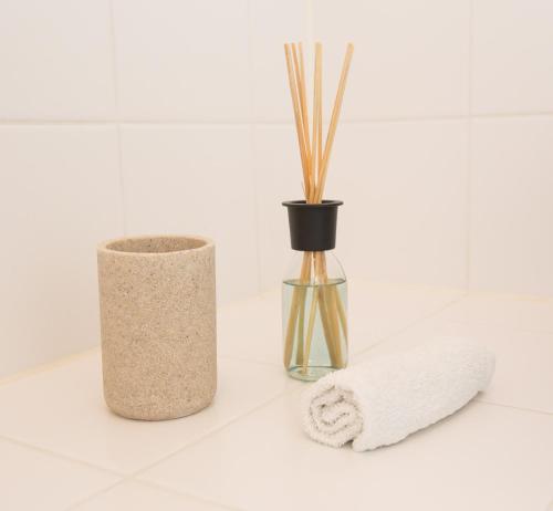 a bathroom counter with a vase and a towel at Apartments Opera in Vienna