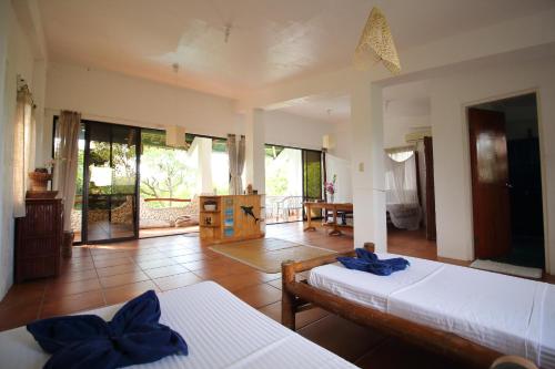 a bedroom with two beds and a room with at The Blue Orchid Resort in Moalboal