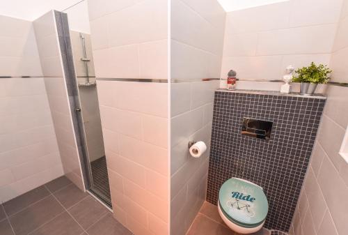 a bathroom with a toilet and a shower at Parliament & River View Apartments in Bucharest