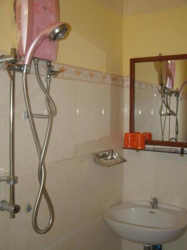 a bathroom with a shower and a sink at Bun Kao Guesthouse in Siem Reap