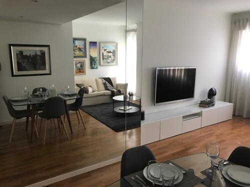 a living room with a couch and a tv at Luxury Apartment T2 - Saldanha in Lisbon