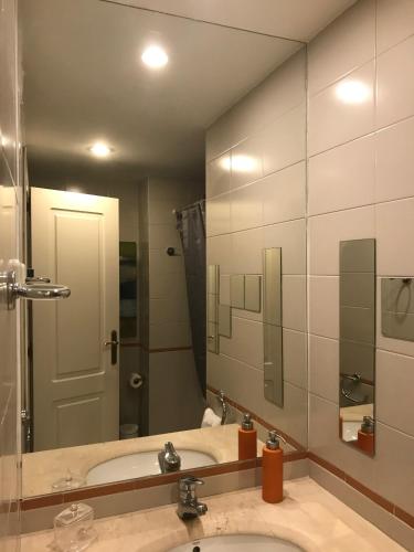 a bathroom with a sink and a large mirror at Luxury Apartment T2 - Saldanha in Lisbon
