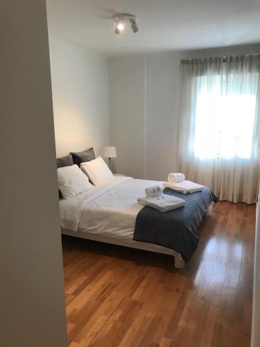a bedroom with a large bed and a window at Luxury Apartment T2 - Saldanha in Lisbon
