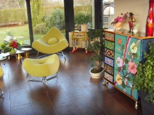 a room with two yellow chairs and a dresser at Chambre D'Hotes Miraflores in Malestroit