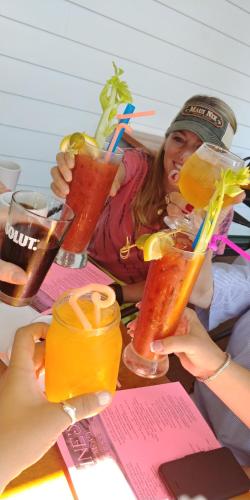 a group of people sitting at a table with drinks at Elaine's Cape May Boutique Hotel in Cape May