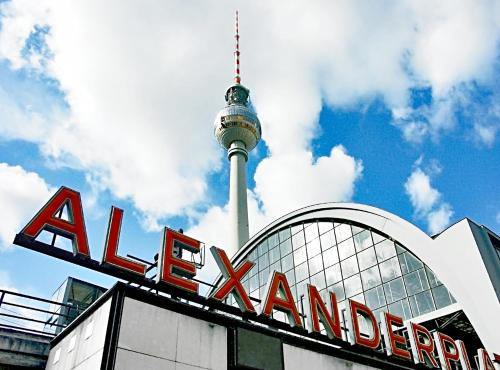 a view of the berlin tv tower and the akron sign at Central Hackescher Markt in Berlin