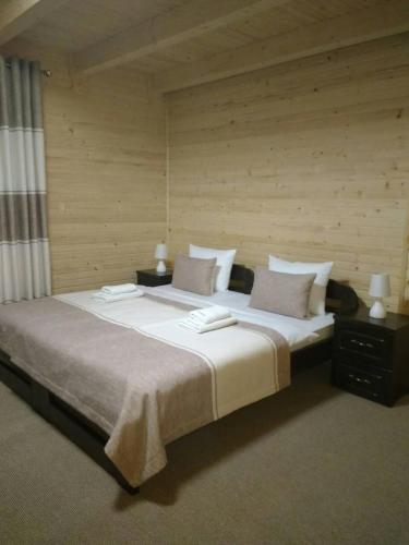 a bedroom with a large bed with two pillows at Family Hotel Kaskad in Bukovel