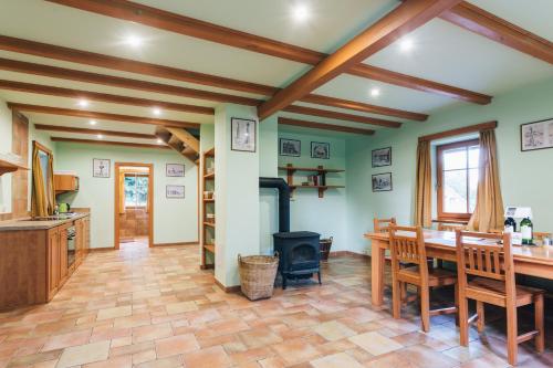 a kitchen with a table and a wood stove at Resort Malevil in Jablonné v Podještědí