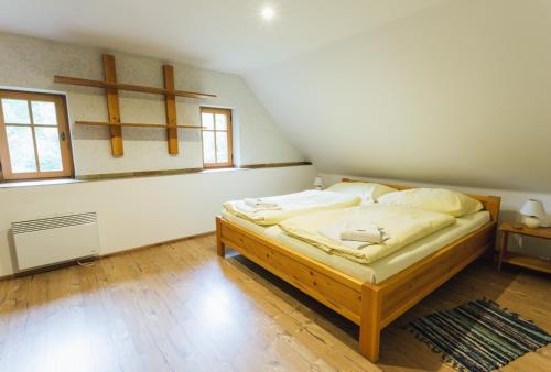 a bedroom with a bed with a cross on the wall at Resort Malevil in Jablonné v Podještědí