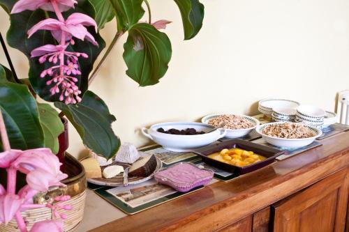 a buffet with bowls of food on a table at Clos Mirabel Manor - B&B in Jurançon