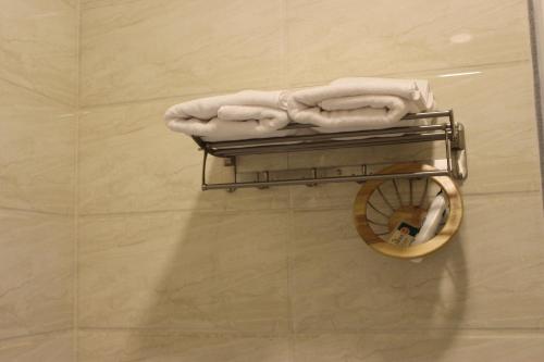 a towel rack with towels on it in a bathroom at Beyout Guest Houses in Ma‘mad