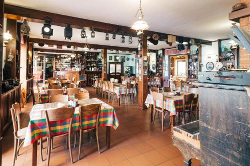 a restaurant with tables and chairs in a room at Resort Malevil in Jablonné v Podještědí
