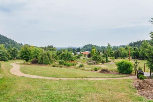 a winding path in a field with trees in the background at Resort Malevil in Jablonné v Podještědí