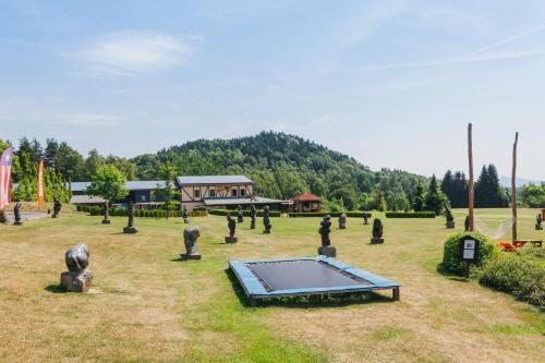 a park with a trampoline in the grass at Resort Malevil in Jablonné v Podještědí