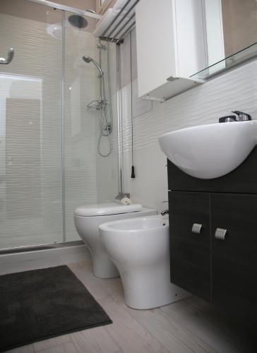 a bathroom with a sink and a toilet and a shower at La dimora di Clara in Trapani